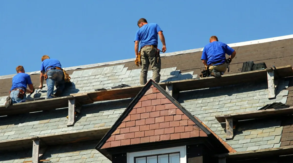 Roof replacement in progress with a team of professional contractors installing new shingles on a residential home in Anaheim, CA